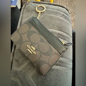 Gently used black and brown signature print coach pebbled leather small wallet